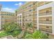 Charming building courtyard with lush greenery, palm trees, and multiple floors of balconies at 1002 S Harbour Island Blvd # 1312, Tampa, FL 33602