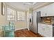 Kitchen featuring stainless steel refrigerator, white cabinets, and wood floors at 1002 S Harbour Island Blvd # 1312, Tampa, FL 33602