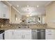 Bright kitchen featuring white cabinets, mosaic backsplash, stainless steel appliances and granite countertops at 1002 S Harbour Island Blvd # 1312, Tampa, FL 33602