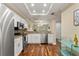 Kitchen featuring white cabinets, stainless steel appliances, and hardwood flooring at 1002 S Harbour Island Blvd # 1312, Tampa, FL 33602