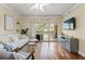 Bright living room with modern furniture, wood floors, balcony access, and a ceiling fan at 1002 S Harbour Island Blvd # 1312, Tampa, FL 33602