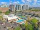 Aerial view of community pool, tennis courts, and lounge areas, surrounded by lush greenery and parking at 1002 S Harbour Island Blvd # 1312, Tampa, FL 33602
