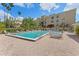 Community swimming pool surrounded by lounge chairs, brick pavers, and lush landscaping at 1002 S Harbour Island Blvd # 1312, Tampa, FL 33602