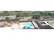 A high aerial view shows the pool area, lake, and surrounding golf-cart community at 1012 Warwick Ct, Sun City Center, FL 33573