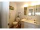 Bathroom with a vanity, toilet, and a mirror reflecting the shower in the background at 1012 Warwick Ct, Sun City Center, FL 33573