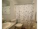 Bathroom featuring a toilet, sink, and floral-patterned shower curtain at 1012 Warwick Ct, Sun City Center, FL 33573