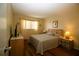 Bedroom with a light wood bed frame, laminate floors, side tables, and a bright window at 1012 Warwick Ct, Sun City Center, FL 33573