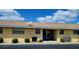Inviting exterior of a condo building with an AC unit and a small courtyard area at 1012 Warwick Ct, Sun City Center, FL 33573