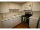 Functional kitchen featuring white cabinets, modern appliances, and laminate countertops at 1012 Warwick Ct, Sun City Center, FL 33573
