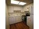 Functional kitchen featuring white cabinets, modern appliances, and laminate countertops at 1012 Warwick Ct, Sun City Center, FL 33573