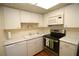 Well-maintained kitchen with white cabinets, modern appliances, and laminate countertops at 1012 Warwick Ct, Sun City Center, FL 33573