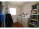 Practical laundry room equipped with a washer, dryer, and a window providing natural light at 1012 Warwick Ct, Sun City Center, FL 33573
