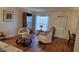 Cozy living room with hardwood floors, comfortable seating, and bright natural light at 1012 Warwick Ct, Sun City Center, FL 33573
