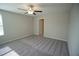 A spacious bedroom is shown with neutral paint and carpeting, as well as a ceiling fan at 1038 Ocean Spray Dr, Ruskin, FL 33570