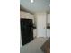 Kitchen featuring a modern black refrigerator and white cabinets at 1038 Ocean Spray Dr, Ruskin, FL 33570