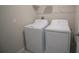 A convenient laundry room is shown, complete with a white washer and dryer at 1038 Ocean Spray Dr, Ruskin, FL 33570