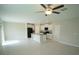 Open floor plan with tile flooring, ceiling fan, and a modern kitchen with white cabinets and black appliances at 1038 Ocean Spray Dr, Ruskin, FL 33570