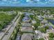 An aerial view showcases a well-maintained home near a tranquil lake and lush green trees, with easy access to nearby roadways at 11308 Callaway Pond Dr, Riverview, FL 33579