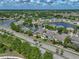 An aerial view highlights the home's proximity to a serene lake, surrounded by beautiful greenery and other well-kept homes at 11308 Callaway Pond Dr, Riverview, FL 33579