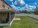 Spacious backyard features a screened porch, lush lawn, and white fencing at 11308 Callaway Pond Dr, Riverview, FL 33579