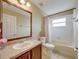 Small bathroom with wood vanity and tub with shower at 11308 Callaway Pond Dr, Riverview, FL 33579