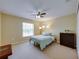 Bedroom with carpet, ceiling fan, and a light teal bed spread at 11308 Callaway Pond Dr, Riverview, FL 33579