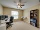 This bedroom features a ceiling fan, a large window, and a modern desk at 11308 Callaway Pond Dr, Riverview, FL 33579