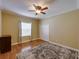 Bedroom with hardwood floors, a ceiling fan, large window and double door closet at 11308 Callaway Pond Dr, Riverview, FL 33579