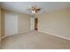 Beige bedroom with carpet, closet, ceiling fan and white door at 11308 Callaway Pond Dr, Riverview, FL 33579
