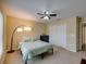 Bedroom with carpet, ceiling fan, and a light teal bed spread at 11308 Callaway Pond Dr, Riverview, FL 33579