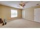 Neutral bedroom with carpet, window, ceiling fan and white door at 11308 Callaway Pond Dr, Riverview, FL 33579
