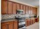 Close-up of modern kitchen with stainless steel appliances and granite countertops at 11308 Callaway Pond Dr, Riverview, FL 33579