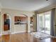 Bright kitchen featuring wood cabinets, tile backsplash, and arched entryways to the dining and living areas at 11308 Callaway Pond Dr, Riverview, FL 33579