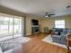 Spacious living room features a stone fireplace, hardwood floors, and sliding glass doors to the patio at 11308 Callaway Pond Dr, Riverview, FL 33579