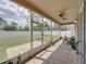 Relaxing screened patio with tile flooring, ceiling fans, and view of the expansive fenced backyard at 11308 Callaway Pond Dr, Riverview, FL 33579
