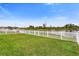 Fenced backyard with serene pond views; perfect for outdoor enjoyment and relaxation at 12017 Grand Kempston Dr, Gibsonton, FL 33534