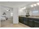 Bathroom vanity with granite countertops, dark cabinets, and decorative lighting fixtures at 12017 Grand Kempston Dr, Gibsonton, FL 33534