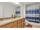 Bathroom featuring double sinks, granite countertops, and a shower with a decorative shower curtain at 12017 Grand Kempston Dr, Gibsonton, FL 33534