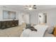 Bright, neutral bedroom with a decorative dresser and views into the ensuite bathroom and walk-in closet at 12017 Grand Kempston Dr, Gibsonton, FL 33534