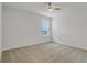 Inviting bedroom with a window, neutral carpeting, and minimalist decor at 12017 Grand Kempston Dr, Gibsonton, FL 33534