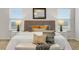Bright bedroom with white bedding, decorative pillows, and neutral walls at 12017 Grand Kempston Dr, Gibsonton, FL 33534