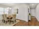 Dining area featuring hardwood floors, neutral walls, chandelier and a wooden table at 12017 Grand Kempston Dr, Gibsonton, FL 33534