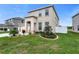 Charming two-story home featuring a landscaped front yard and an inviting entryway at 12017 Grand Kempston Dr, Gibsonton, FL 33534