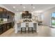 Modern kitchen with stainless steel appliances, granite countertops, and an island with bar seating, perfect for cooking at 12017 Grand Kempston Dr, Gibsonton, FL 33534