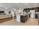 Open concept kitchen with large island, stainless appliances, and seamless flow into the living area at 12017 Grand Kempston Dr, Gibsonton, FL 33534