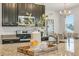 Granite countertops and dark cabinetry accent this kitchen's stylish decorative touches and stainless steel appliances at 12017 Grand Kempston Dr, Gibsonton, FL 33534