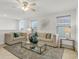 Bright living room with plush seating, ceiling fan, and glass coffee table, perfect for entertaining at 12017 Grand Kempston Dr, Gibsonton, FL 33534