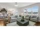 Bright and airy living space features a comfortable couch, hardwood floors, and modern lighting, perfect for relaxation at 12017 Grand Kempston Dr, Gibsonton, FL 33534