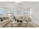 Bright, open living room with comfortable sofas, a glass coffee table, and large windows at 12017 Grand Kempston Dr, Gibsonton, FL 33534