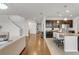 Open-concept living area showcasing hardwood floors and a modern kitchen with an island and barstool seating at 12017 Grand Kempston Dr, Gibsonton, FL 33534